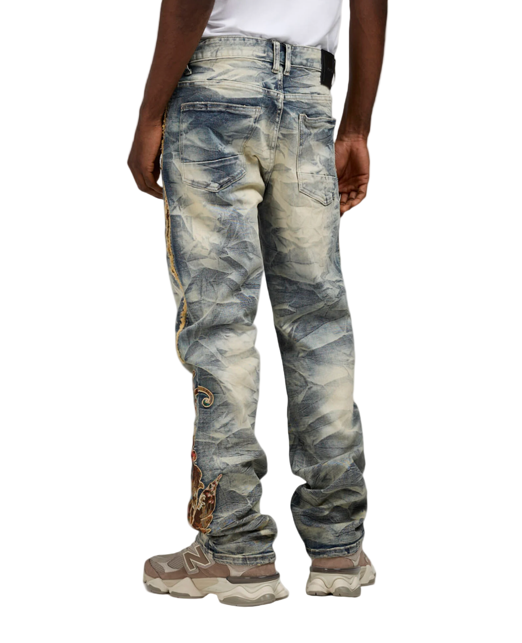 Distressed jeans worn by a person on a white background